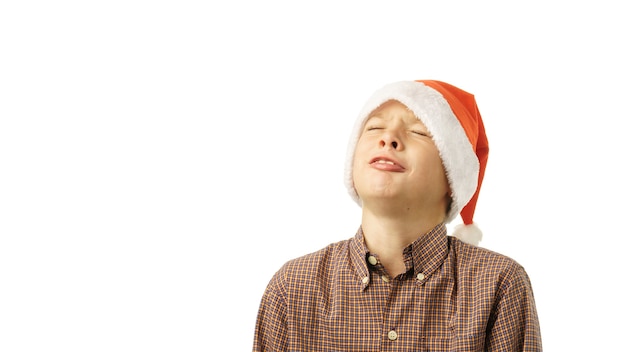 Boy in Santa Claus hat isolated on white background.