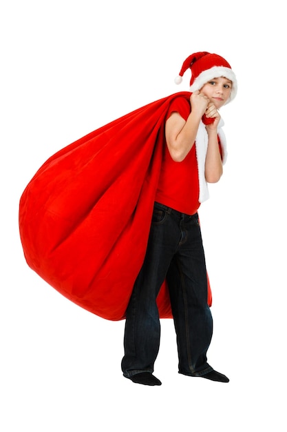 Boy in Santa Claus hat with red Christmas Gift Bag on white