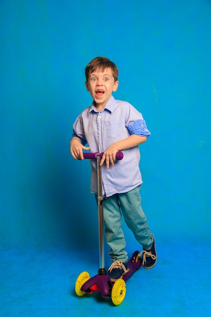 A boy on a scooter on a blue background  An article about childrens scooters