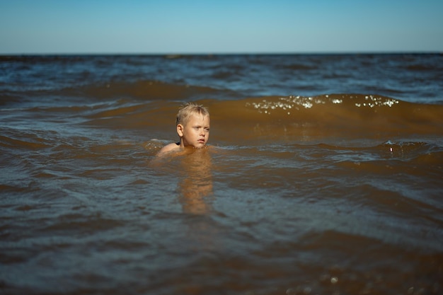 Boy in the sea Learning to swim