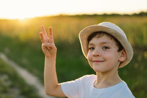 The boy shows with his fingers the number three or trident coat of arms of Ukraine Ukrainian statehood