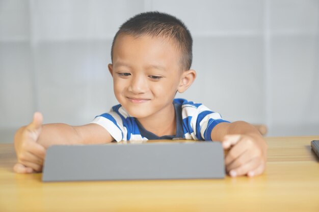 Boy sitting happily studying online