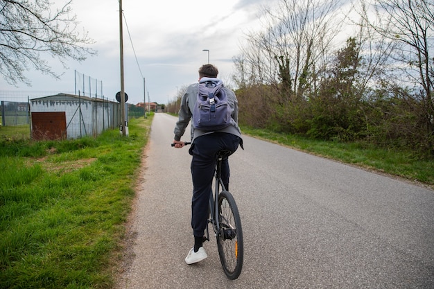 Boy sitting on his bicycle is about to take a ride.