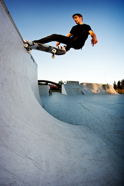 Boy skateboarding in a skatepark in the afternoon