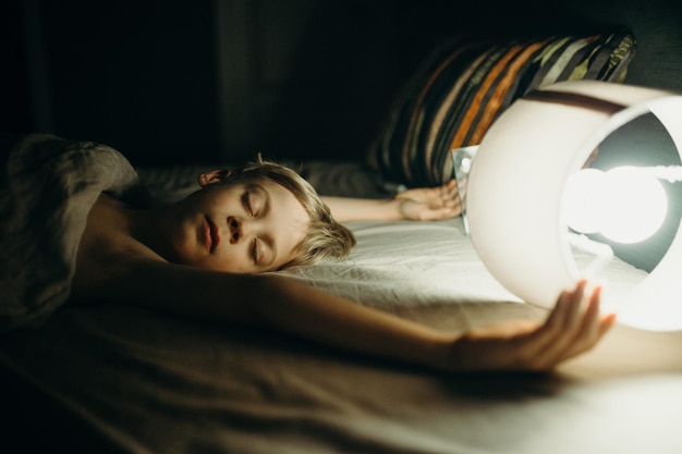 Boy sleeping on bed at home