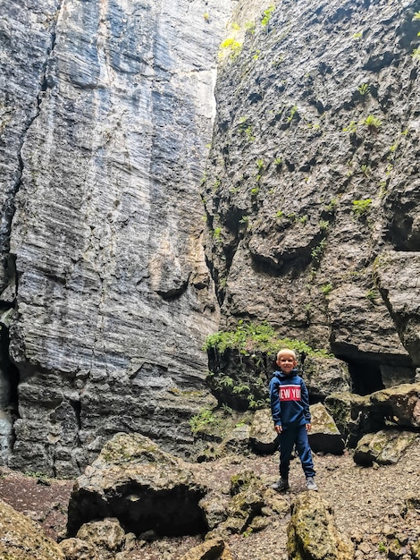 A boy in the Stone Bowl Gorge A gorge in the mountains of the landscape nature of Dagestan Russia