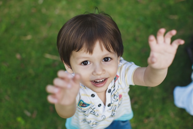 Boy stretches his hands to his father