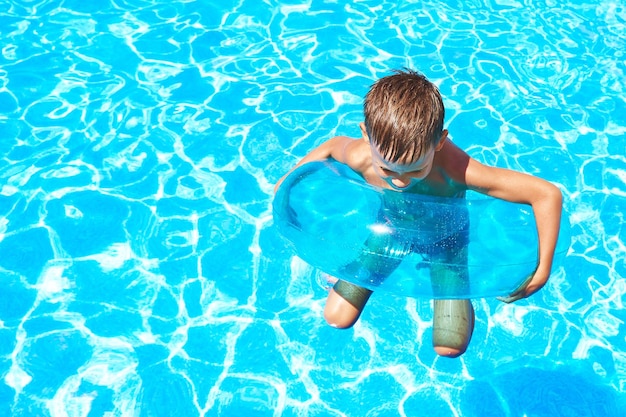 Boy swimming into pool