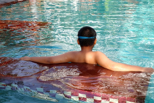 boy swimming in pool