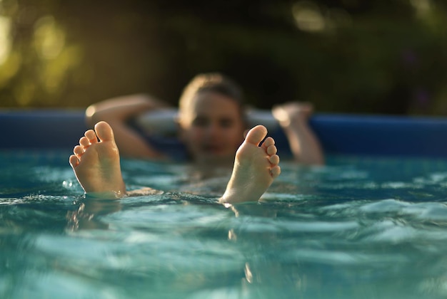 A boy swims in the pool in the summer heat