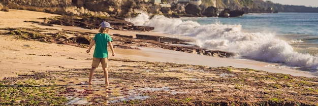 Boy tourist on pantai tegal wangi beach bali island indonesia bali travel concept traveling with