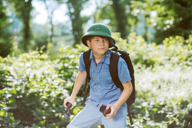 Boy traveler in helmet play in the park