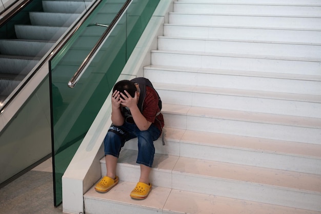 Boy do not want to go to school mother hit her kid children crying little boy cry feeling sad young boy unhappy family violence concept selective focus and soft focus