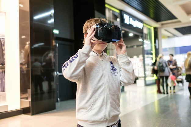 Boy wearing virtual reality glasses playing the game3D gadget headset goggles technology Cardboard VR glasses