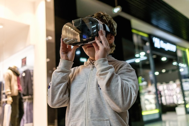 Boy wearing virtual reality glasses playing the game3D gadget headset goggles technology Cardboard VR glasses