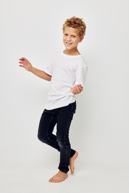 Boy in a white tshirt barefoot in full growth