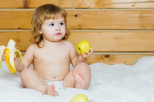 Boy with banana and apples