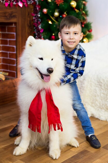 A boy with a big dog at Christmas.