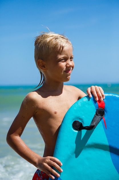 A boy with a bodyboard on a wave