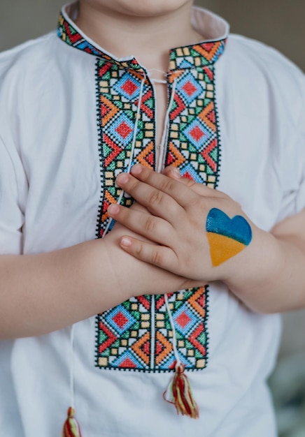 a boy with the flag of Ukraine Ukrainian embroidery flag of Ukraine a child in white