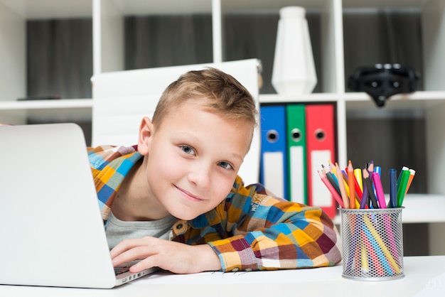 Boy with laptop at desk