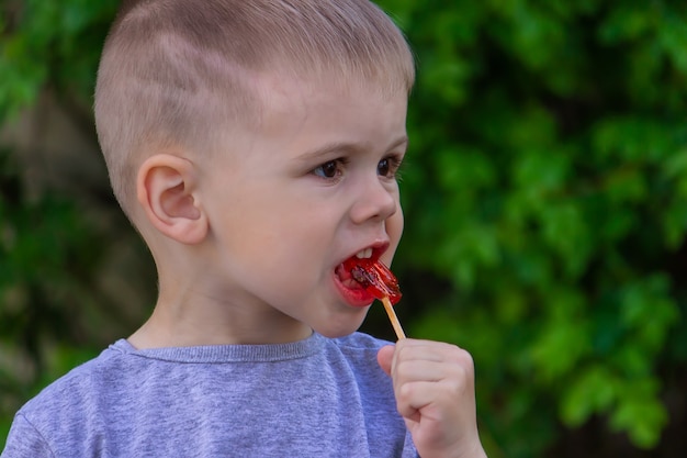 Boy with a lollipop on a green surface