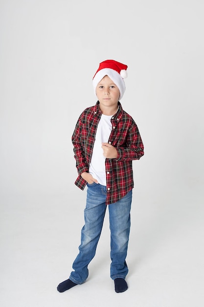 A boy with a white background holds a musical instrument in the New Year's room