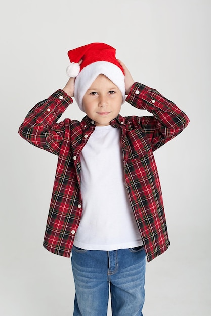 A boy with a white background holds a musical instrument in the New Year's room