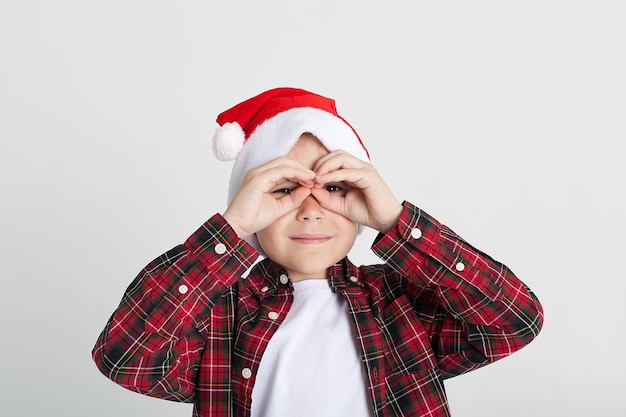 A boy with a white background holds a musical instrument in the New Year's room