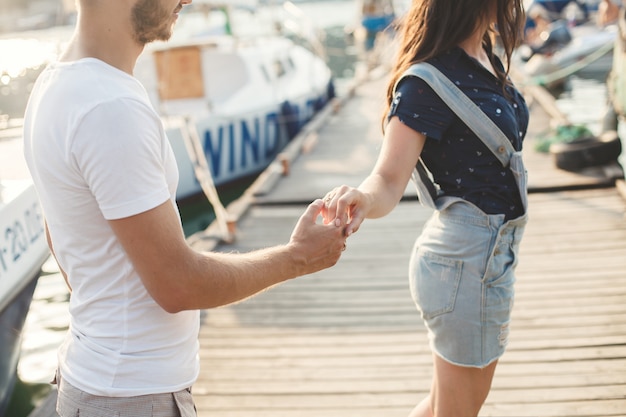 Boyfriend and girlfriend posing in a harbor