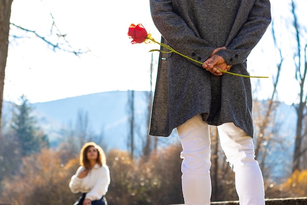 Boyfriend hiding a surprise rose for her girlfriend Latin man hiding a rose for her boyfriend on valentine39s day