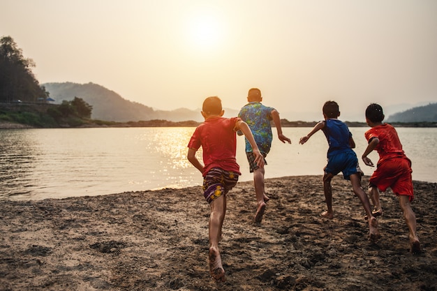 boys running in the water and having fun on the lake