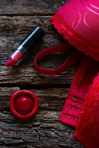 Bra and contraception on a wooden background