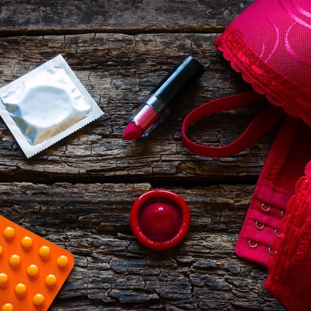 Bra and contraception on a wooden background