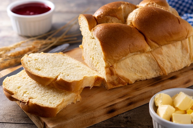 Braided egg bread on wooden table