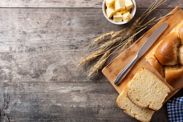 Braided egg bread on wooden table