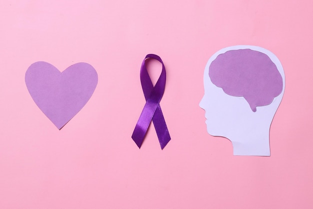 Brain paper cutout purple ribbon awareness and purple heart shape World epilepsy day