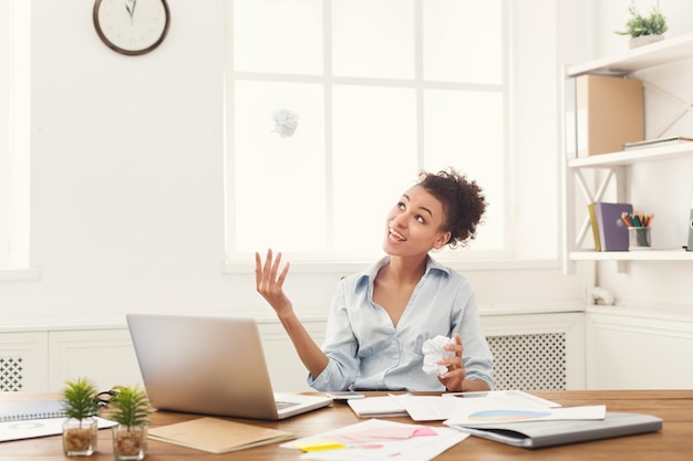 Brainstorm. Cheerful business woman at workplace thinking about work strategy in modern office, copy space