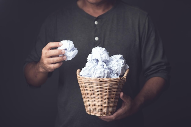 Brainstorm or create an idea Trying to innovate of new think The process of successful Hand holding white used crumpled paper Studi shot