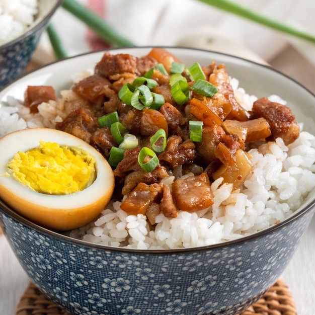 Braised meat rice, close up of stewed pork over cooked rice in Taiwan. Taiwanese famous traditional street food delicacy.