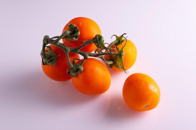 Branch of fresh red tomatoes on black and white background