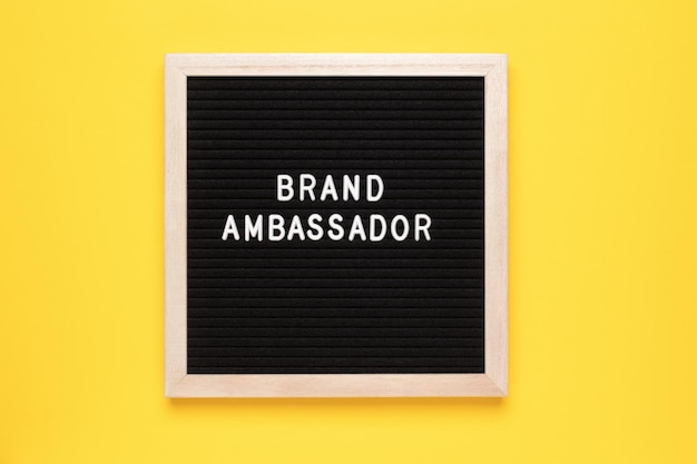 Brand Ambassador Text on letter board on yellow background