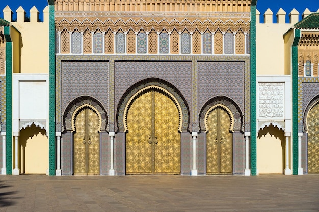 Brass gate zellige mosaic tilework and carved cedar woods on Dar alMakhzen or Dar elMakhzen royal palace in Fez Morocco