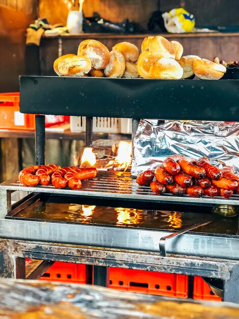 Bratwurst sausages and bread on grill 