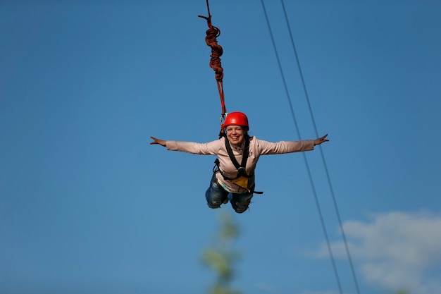 The brave girl jumped from the bridge and flies in the skyengage in ropejumpingdangerous hobbies