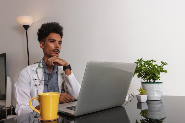 Brazilian Black Doctor or Veterinarian Working at Home Young Man Doing Home Office During the day at desk With Laptop