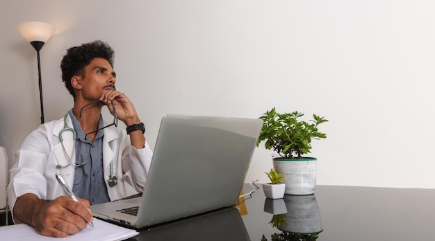 Brazilian Black Doctor or Veterinarian Working at Home Young Man Doing Home Office During the day at desk With Laptop