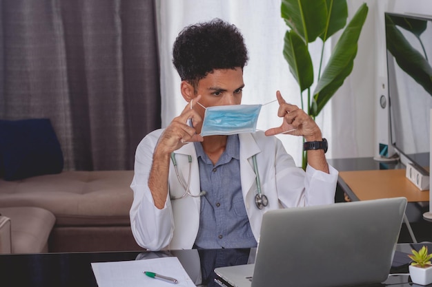 Brazilian Black Doctor or Veterinarian Working at Home Young Man Doing Home Office During the day at desk With Laptop