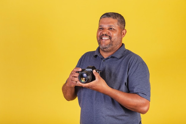 Brazilian black man adult holding photo camera photography hobby photographer