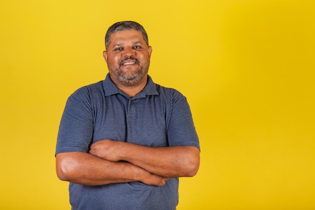 Brazilian black man adult smiling looking at camera With arms crossed confident